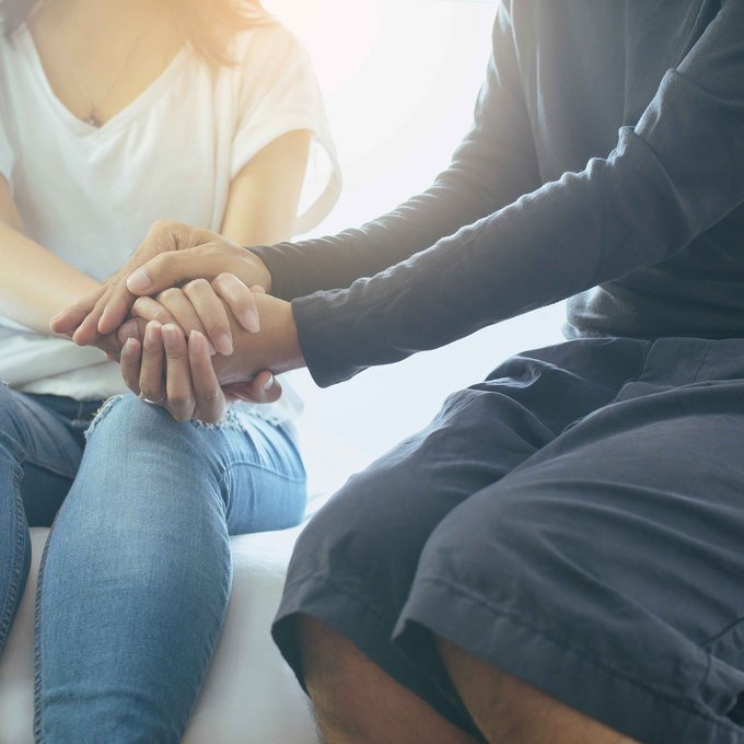 Zwei Personen halten sich an den Händen